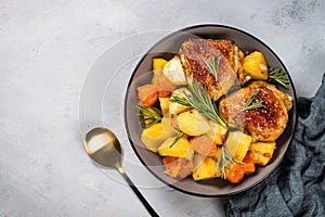 Baked chicken with vegetables top view.