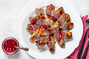 Baked chicken wings in cranberry sauce top view.