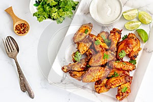 Baked Chicken Wings Garnished with Cilantro Top Down Photo on White Background