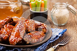 Baked chicken wings in honey sauce sprinkled with sesame seeds