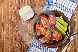 Baked chicken wings in honey sauce sprinkled with sesame seeds