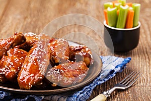 Baked chicken wings in honey sauce sprinkled with sesame seeds