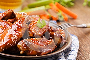 Baked chicken wings in honey sauce sprinkled with sesame seeds
