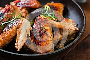 Baked chicken wings in pan.