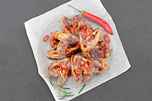 Baked chicken wings with sauce. Food background. Top view