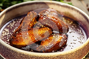 Baked chicken wings in sauce and sprinkled with sesame seeds