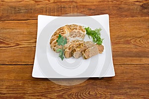 Baked chopped pork liver pate on dish on rustic table