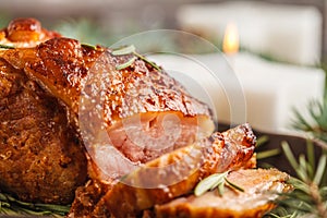 Baked Christmas pork ham with rosemary on Christmas table
