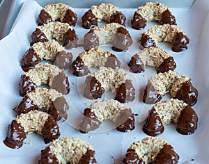 Baked christmas sweets on baking tray freshly covered in chocolate