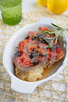 Baked cod under tomato sauce