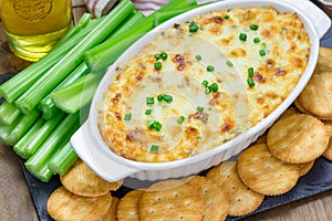 Baked crab dip, served with celery sticks, crackers
