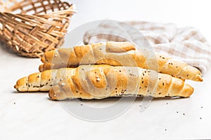 Baked croissant. Crispy bun roll on white table