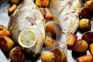 Baked Dorado fish baked with patatoes and carrot