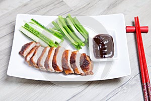 Baked duck with hoisin sauce, cucumbers and shallots.