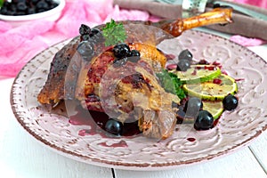 Baked duck leg confit with berry sauce on a plate. Holiday menu