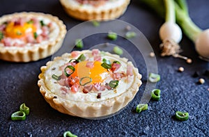 Baked egg and bacon tartlets