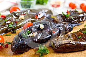 Baked eggplant, garlic, fresh herbs - ingredients for a snack `Melindzano`.