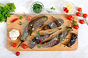 Baked eggplant, garlic, fresh herbs - ingredients for a snack `Melindzano`.