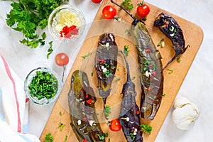Baked eggplant, garlic, fresh herbs - ingredients for a snack `Melindzano`.