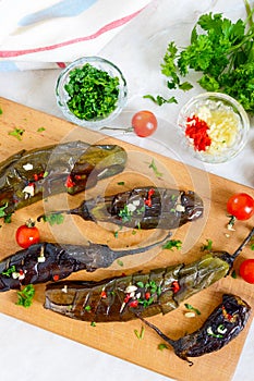 Baked eggplant, garlic, fresh herbs - ingredients for a snack `Melindzano`.