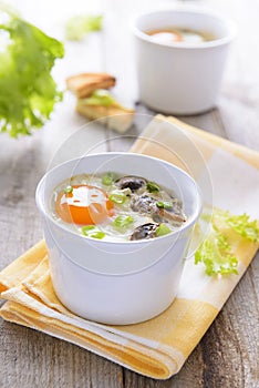 Baked eggs with mushrooms on wooden table