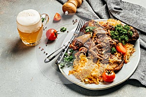 Baked Eisbein with sauerkraut and beer. Roasted knuckle of pork. German cuisine, Oktoberfest
