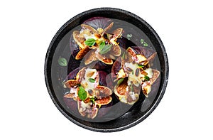 Baked figs with goat cheese, vermouth, honey and walnuts. Isolated, white background.