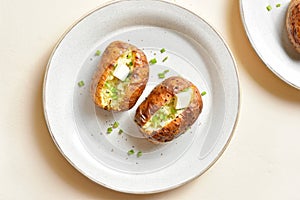 Baked filled potatoes with butter and green onion