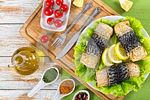 Baked fillet of mackerel on lettuce salad on white platter