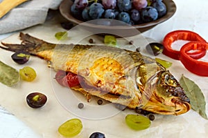 Baked fish carp, stuffed bell peppers and grapes