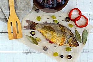 Baked fish carp, stuffed bell peppers and grapes.