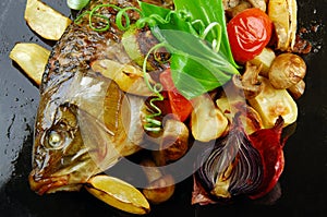 Baked fish with vegetables photo