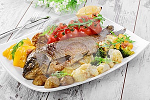 Baked fish with vegetables photo