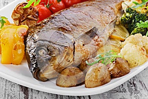 Baked fish with vegetables photo