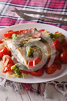 Baked Flounder with peppers and broccoli close-up. Vertical
