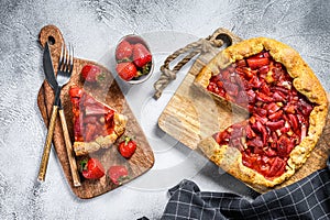 Baked galette with strawberry and rhubarb. Homemade pie, tarte. Gray background. Top view