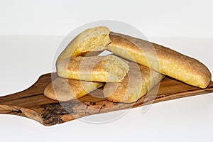 Baked golden bread loaf on a wooden chopping board