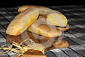 Baked golden bread loaf on a wooden chopping board