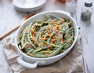 Baked green bean casserole topped with french fried onions photo