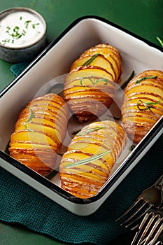 Baked hasselback potato with cheddar cheese and rosemary