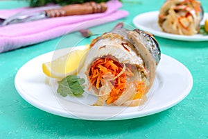 Baked herring stuffed with vegetables. Tasty fish rolls