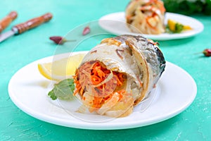 Baked herring stuffed with vegetables. Tasty fish rolls