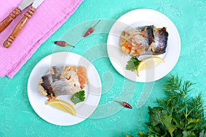 Baked herring stuffed with vegetables. Tasty fish rolls. The top view
