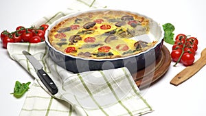 Baked homemade quiche pie in ceramic baking form