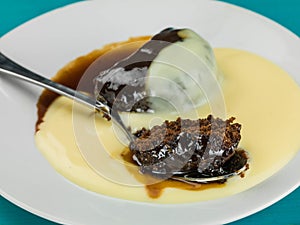 Baked Homemade Sticky Toffee Pudding Dessert Served With Hot Custard