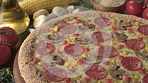 Baked Italian pizza with salami corn mushrooms and cheese