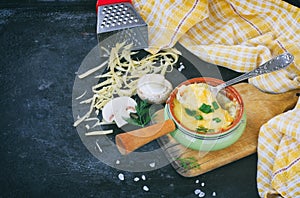 Baked julienne with champignons, onions and cheese on black table