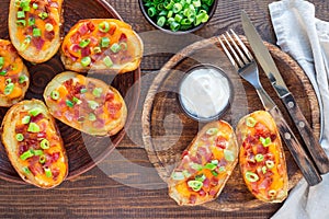 Baked loaded potato skins with cheddar cheese and bacon, garnish