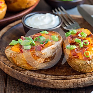 Baked loaded potato skins with cheddar cheese and bacon, garnish