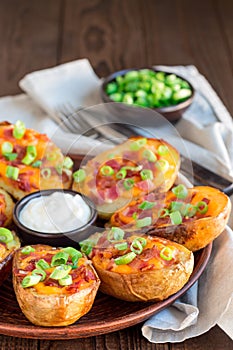 Baked loaded potato skins with cheddar cheese and bacon, garnish